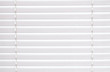© familylifestyle - Blinds of white color texture on the window.