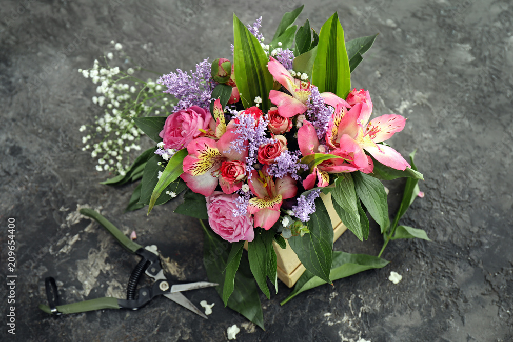 Gift box with beautiful flowers on table