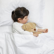 © DN6 - Child girl sleeping with teddy bear on the wooden bed in her bedroom, Happy asian child little girl with her teddy bear, family concept at home