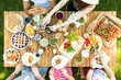 © Photographee.eu - Top view of a table with Italian food and friends eating and drinking in the garden