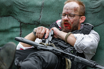 man in blood with gun in his hand