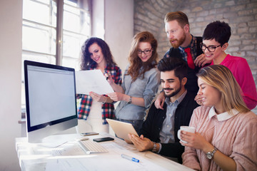 Group of young architects using digital tablet