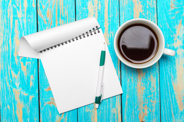 Wall Mural - Cup of coffee with notebook on wooden desk