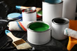 © Pixel-Shot - Cans of paint, roller and brush on plastic cover