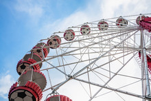 Underside View Of A Ferris Wheel On The Blue Sky Background