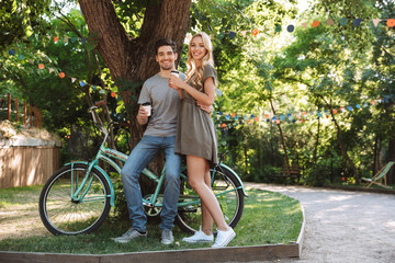 Wall Mural - Full length image of Cheerful lovely young couple posing together