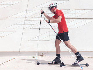 A young man cross-country skiing with rollerski