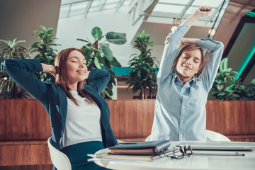 Wall Mural - Two women exercising stretching in office.