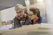 © goodluz - Industrial woodwork technicians meeting with digital tablet