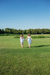 © Olga Zarytska - Two girls running out on the field. Sisters in blue dresses. Summer leisure.