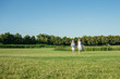 © Olga Zarytska - Two girls running out on the field. Sisters in blue dresses. Summer leisure.