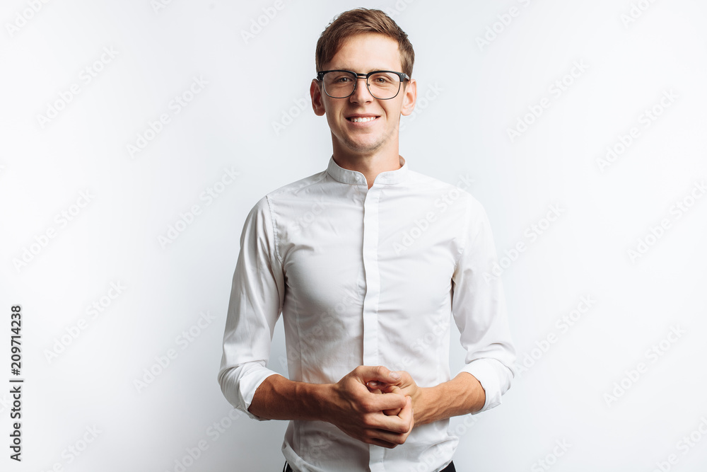 Portrait of young attractive guy in glasses, in white shirt, isolated on white background, for advertising, text insertion - obrazy, fototapety, plakaty 