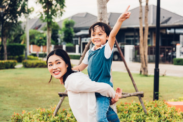 Family happy children kid son boy kindergarten ride back piggyback mother mom