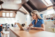 © bnenin - Young woman working on laptop in open space modern office.