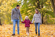 © Syda Productions - family, season and people concept - happy mother, father and little daughter walking at autumn park