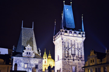 Two castle tower at night near Lesser Town square