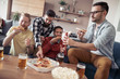 © ivanko80 - Male friends playing video games and eat pizza