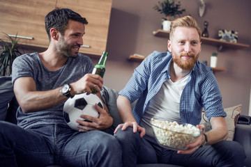 Poster - Two friends watch a football game at home