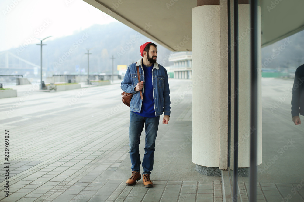 Handsome trendy hipster walking outdoors