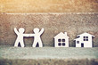 little wooden men and house on natural background. Symbol of construction, neighborhood, sweet home concept