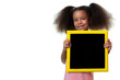 Cute african american small girl holding a blackboard with space for text