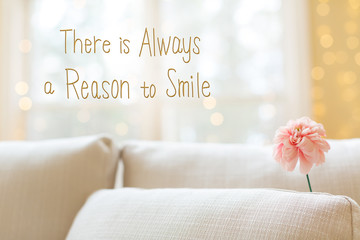there is always a reason to smile message with a flower in a bright interior room sofa