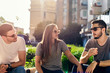 © qunica.com - Great shot of attractive group of young friends having fun sitting at the bench on a sunset