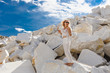 © Alyona - emotional happy beautiful young woman on white rocks outdoors