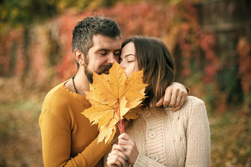 love and relations. autumn happy couple in love with yellow maple leaves