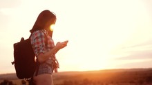Hipster Hiker Silhouette Girl Wanderer Search Position Navigation On Mobile Phone Smartphone To Find Right Way During Slow Motion Video Adventure Nature Travel. Woman Hiker Checks Weather Forecast Via