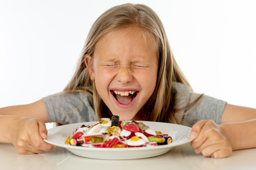 sugar high young blonde girl eating too much sugar in nutrition concept