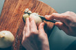 © andrey gonchar - The cook cuts the onion on a cutting board