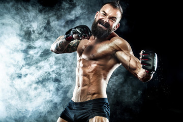 Sportsman boxer fighting on black background with smoke. Copy Space. Boxing sport concept.