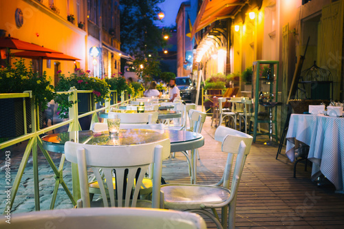 Fotomural Outdor restaurant terrace at night old European city street.