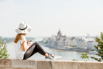 Wall Mural - Young woman tourist enjoying great citysacape view traveling in Budapest city, Hungary