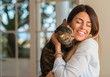 © Krakenimages.com - Young beautiful woman smiling and cuddling cat with love at home.
