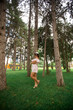 © Aleksandr - Beautiful girl indress and hat in the park. Green grass and sunny. Background of trees