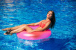 © Aleksandr - Sexy girl sunbathing in the pool on a round mattress