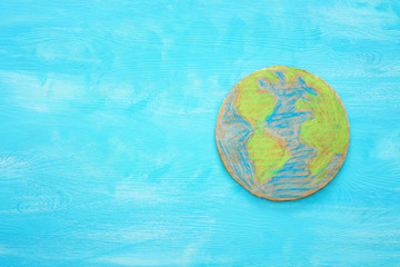 top view image of earth globe over blue wooden background.