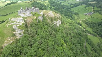 Sticker - Aerial drone view of the ruins of a medieval castle located on a hilltop overlooking farmland (Carreg Cennen, Wales)