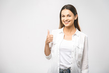 Young Happy Cheerful Woman Showing Thumb Up. Confident Young Businesswoman Giving The Thumbs Up Against A White Background. Place For Text.