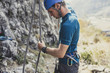 © LStockStudio - Male Climber Preparing for Climbing Outdoors