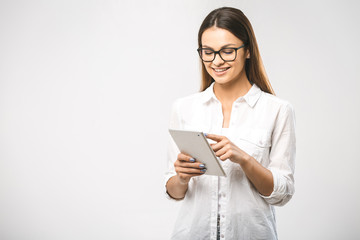 Wall Mural - Portrait with copy space empty place of pretty charming confident trendy woman in classic shirt having tablet in hands looking at camera isolated on white background