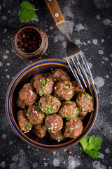 Wall Mural - Beef meatballs in bowl with sauce, brown with sesame and parsley, tatsy snack