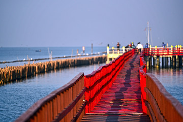 People come to watching dolphin at wooden red bridge, Gulf of Thailand, near by Tha Chin estuary, Samutsakhon province, Thailand