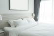 white bedding and pillow in hotel room, pillows on the bed with wall lamp