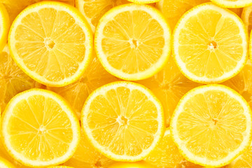 A slices of fresh juicy yellow lemons.  Texture background, pattern