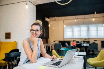 Portrait of smiling entrepreneur girl indoors.