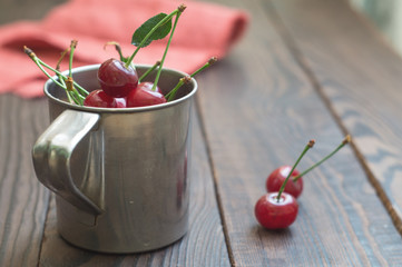 Ripe cherry in a metal mug