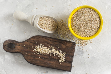 Canvas Print - organic quinua cereal in color bowl on white background